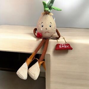 Adorable Cry Baby Stuffed Toy with Green and Brown Accents